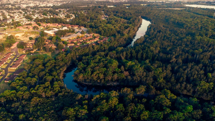 an aerial view of a city surrounded by forest