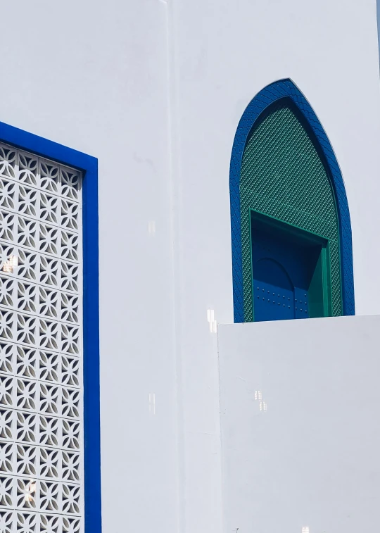 this white building has a blue window and door