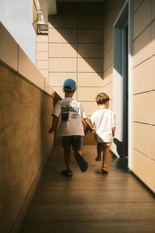 two small boys walking next to each other on stairs