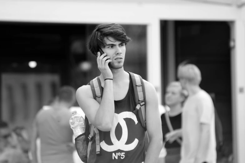 an unknown man talks on his cell phone in black and white
