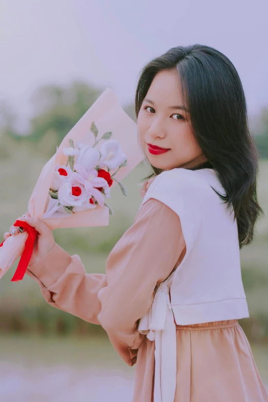 there is a woman holding some flowers in her hands