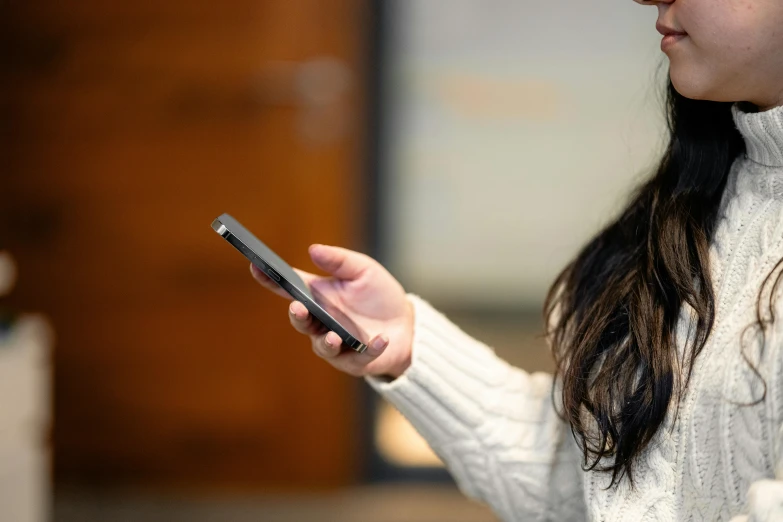 a woman using a cell phone in her hand