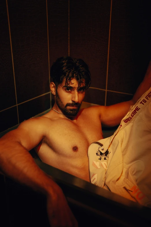 shirtless man with short hair and beard in the bath