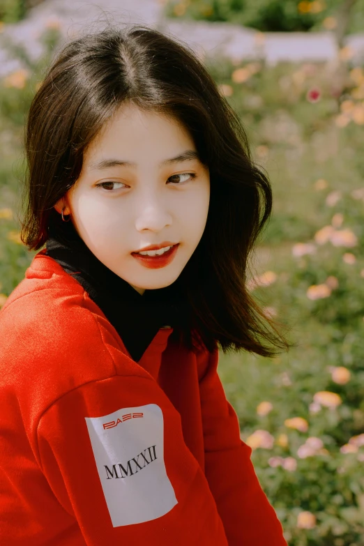 an asian woman standing outside with long hair