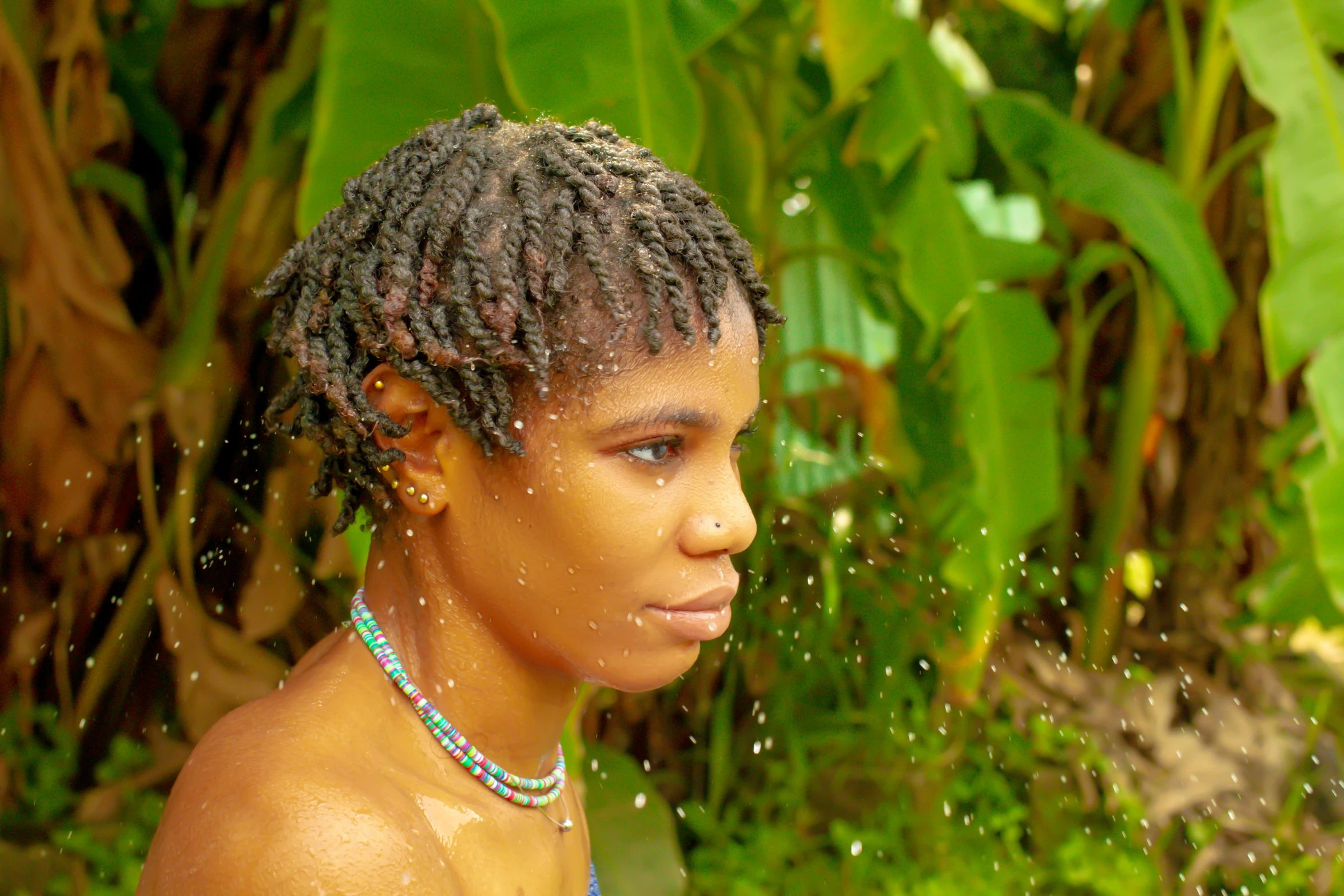 a woman who is drinking from a water hose