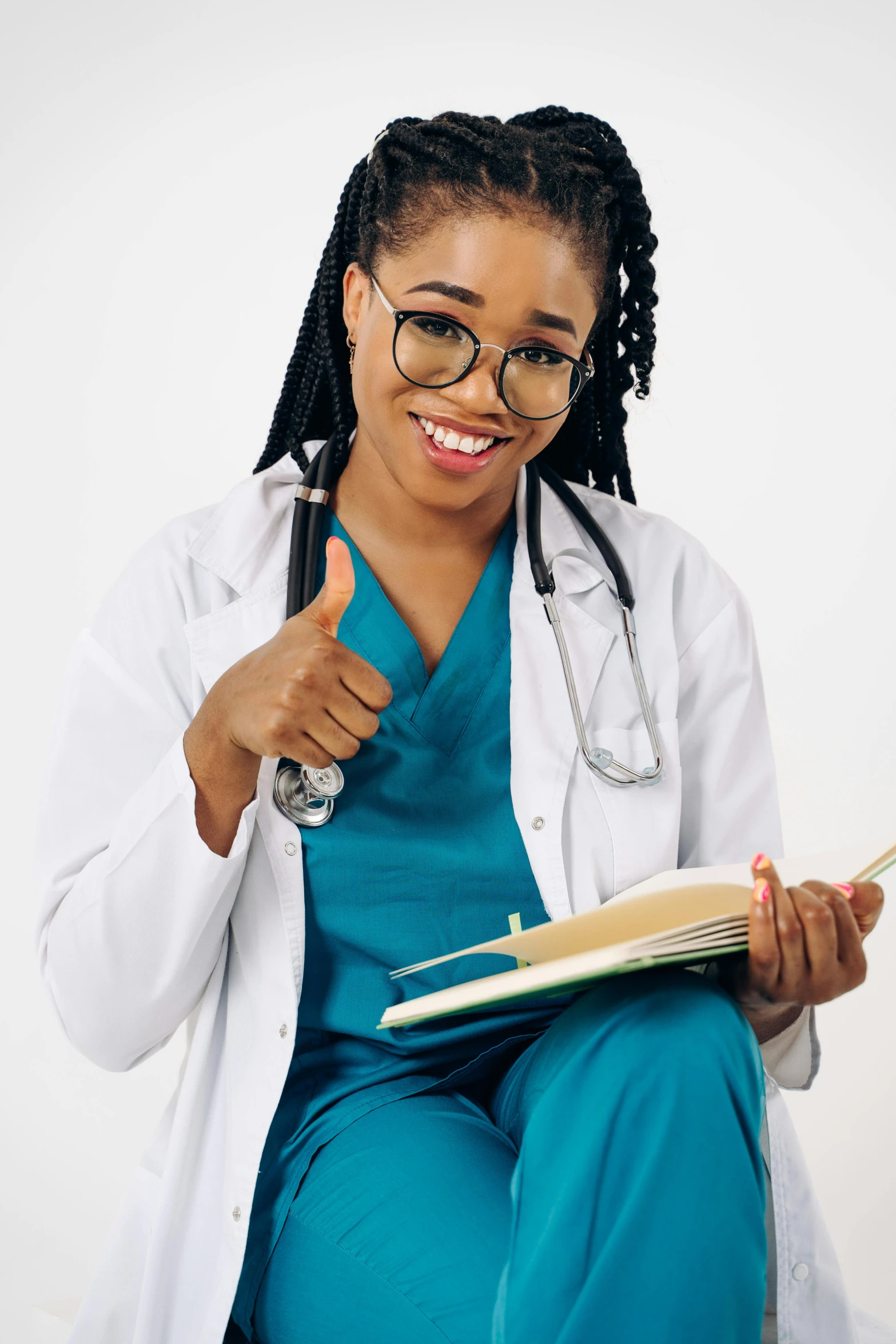 a woman in a white coat with her thumbs up