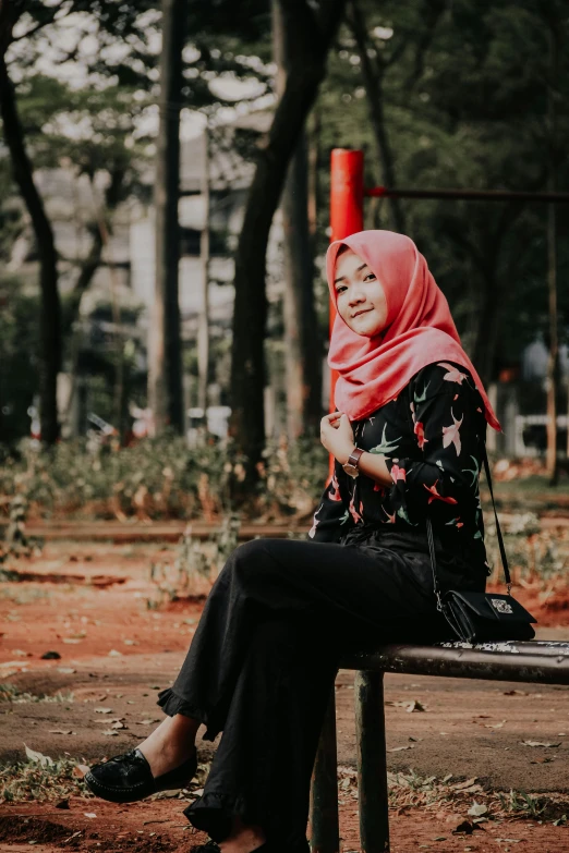 a woman sitting on top of a bench