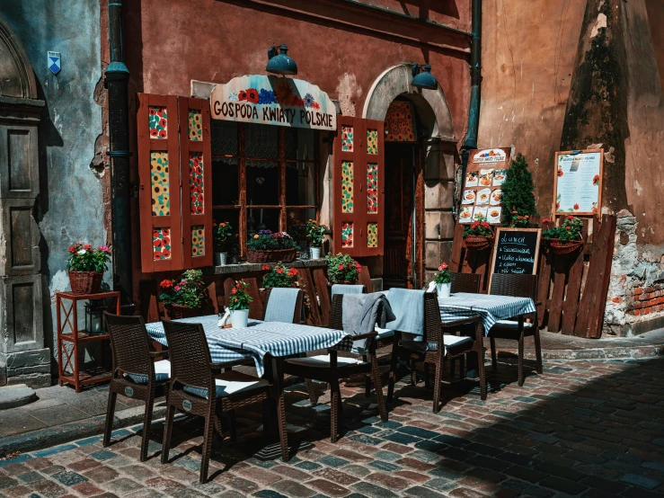 an outdoor dining area with tables and chairs