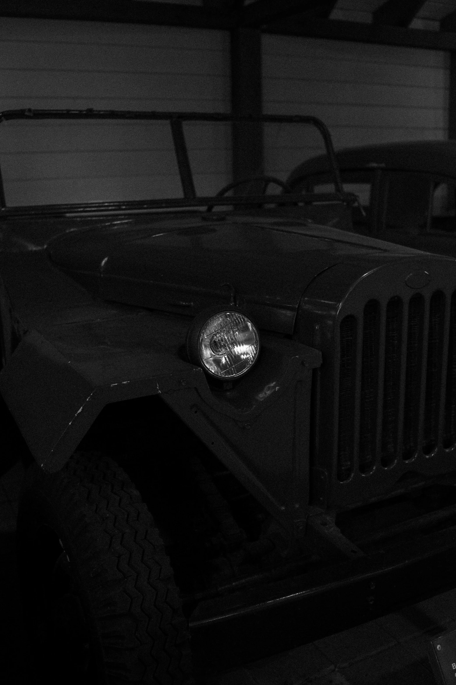 an old car is sitting in a dark room