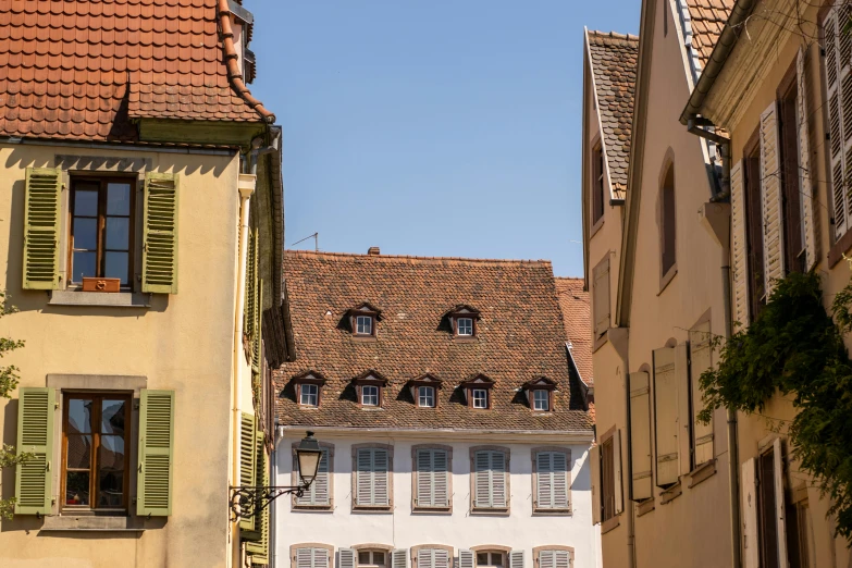 a number of buildings with green shutters on each side