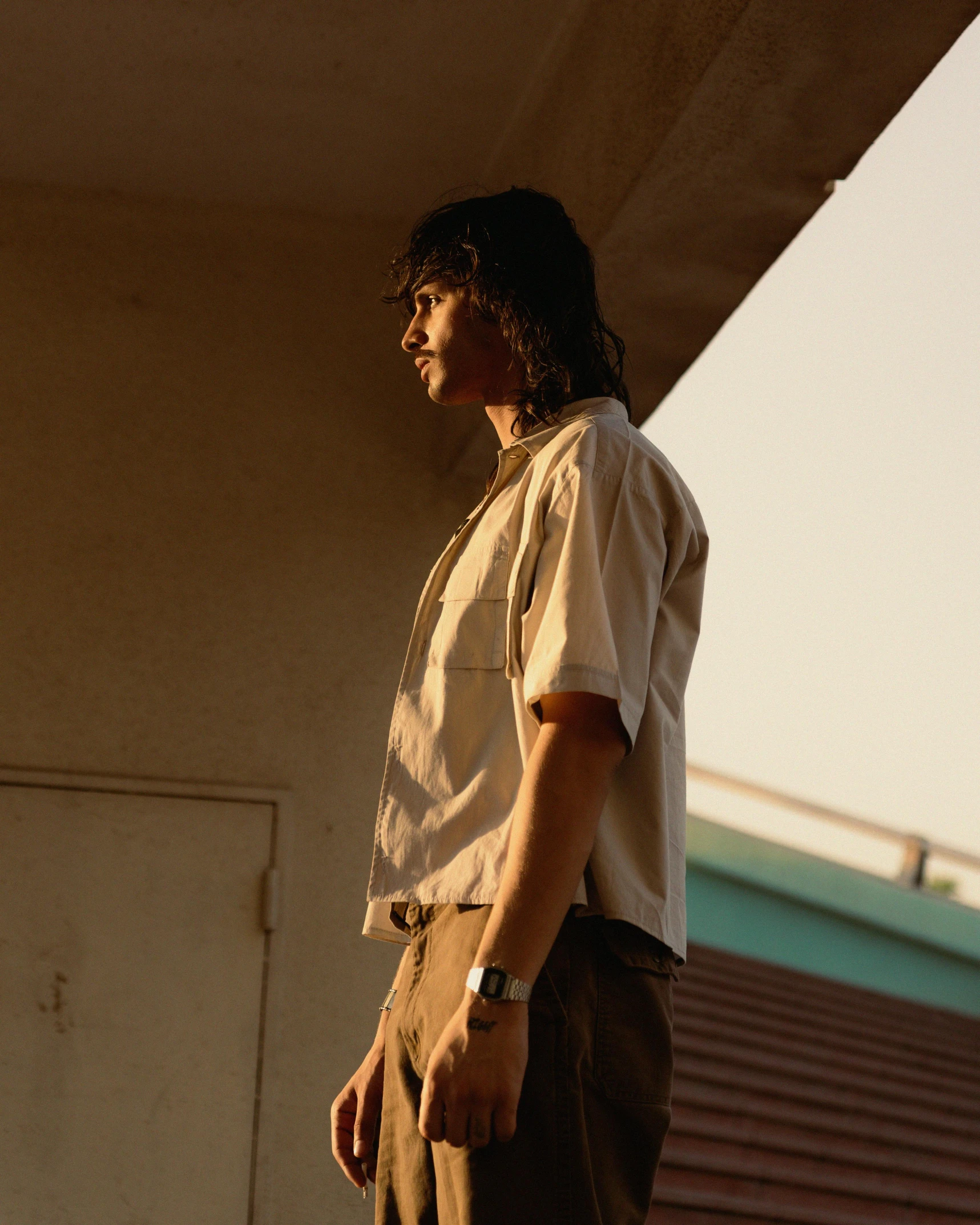 a young man standing in front of a building