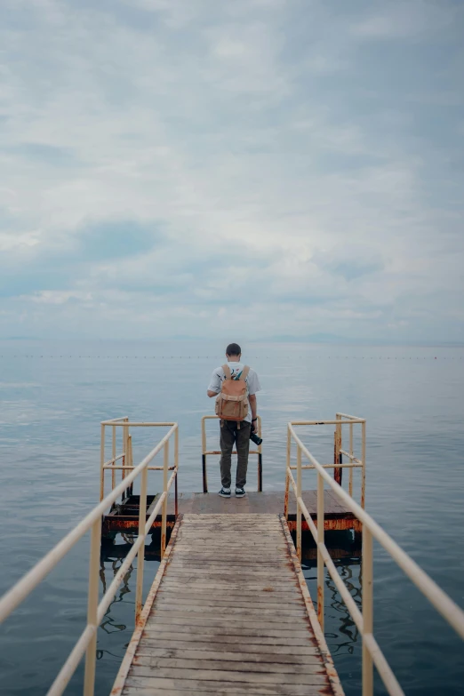 the man stands on the dock waiting for soing to be taken