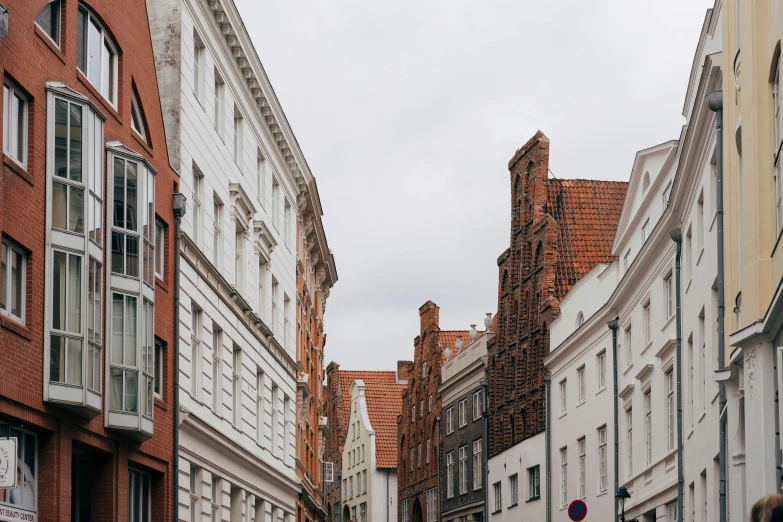 a narrow street with tall buildings next to it