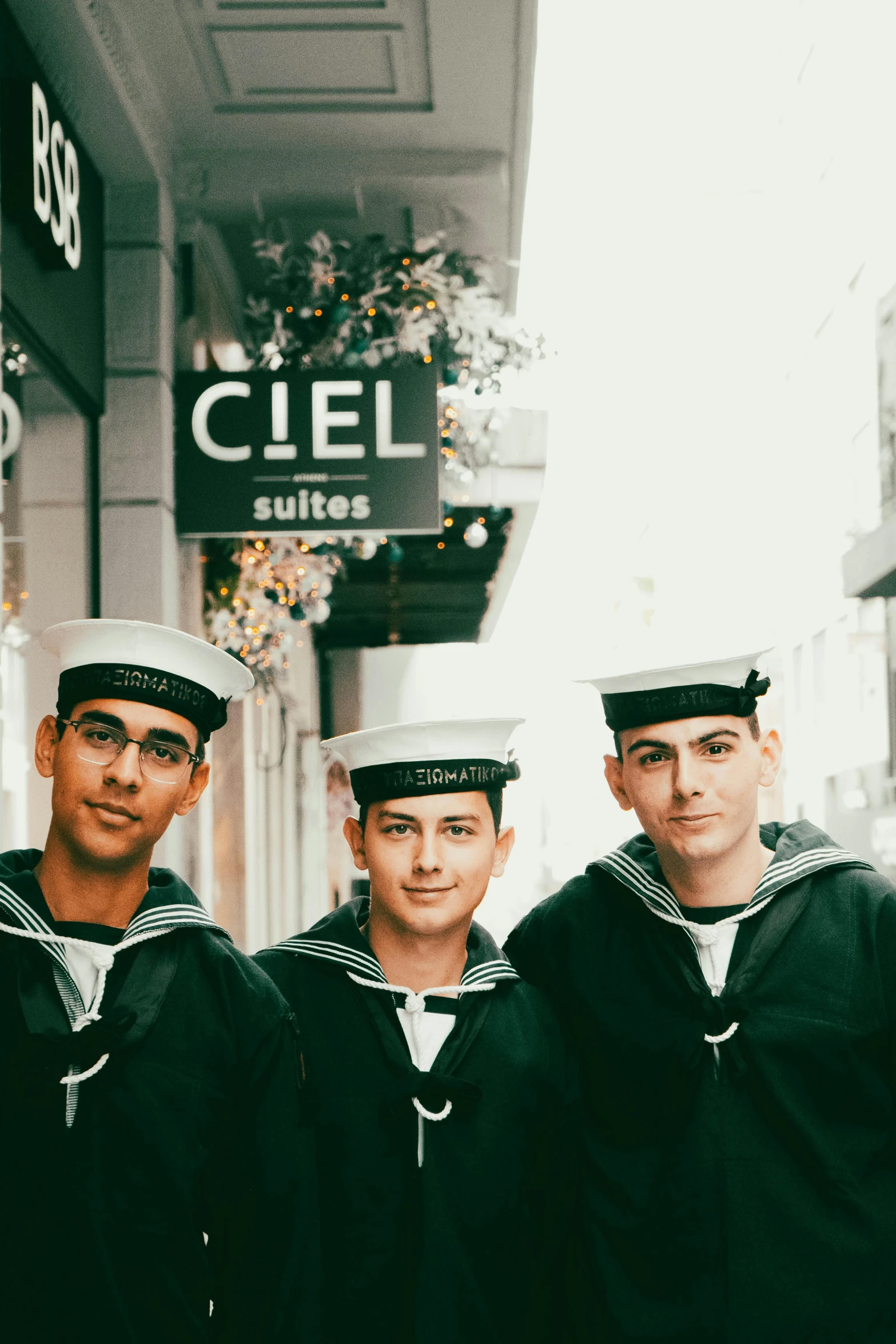 four men standing next to each other wearing hats