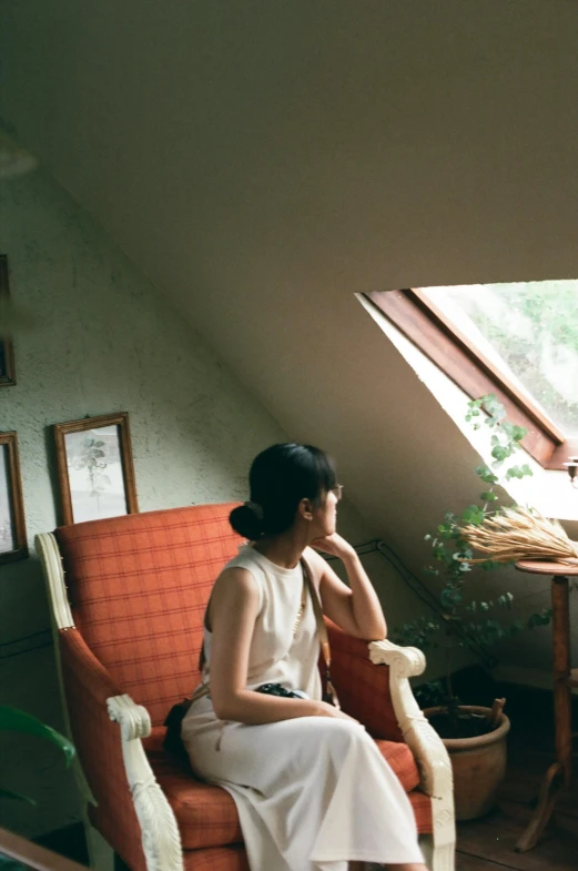 the woman sits on the chair in the loft