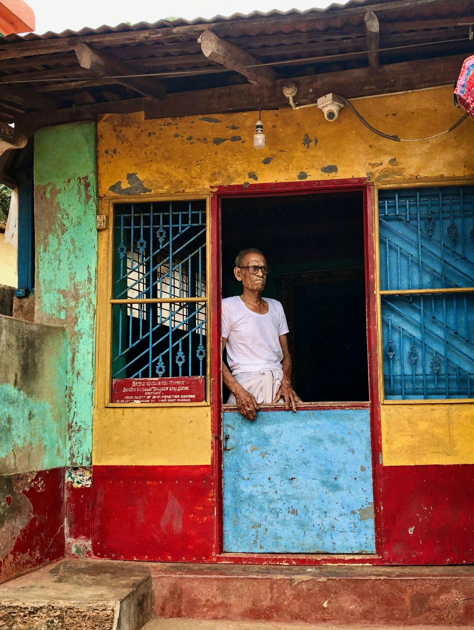 man standing in doorway with bright colored walls