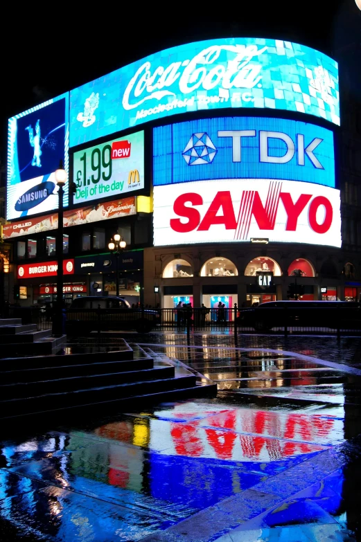 the view of a large billboard at night in tokyo