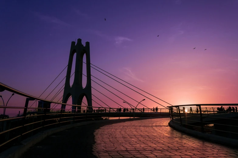 the view from the bridge shows a long path with a man walking across