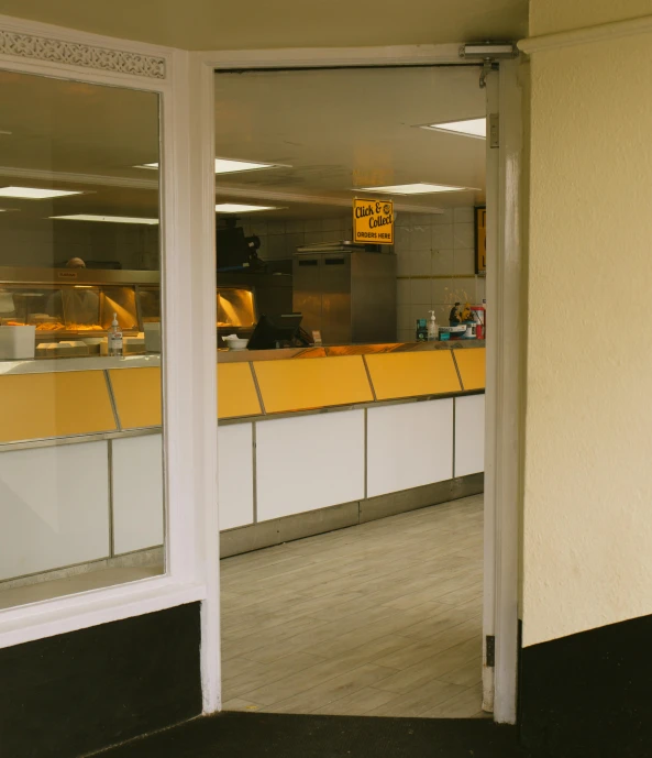 this is an image of a empty restaurant with yellow counters