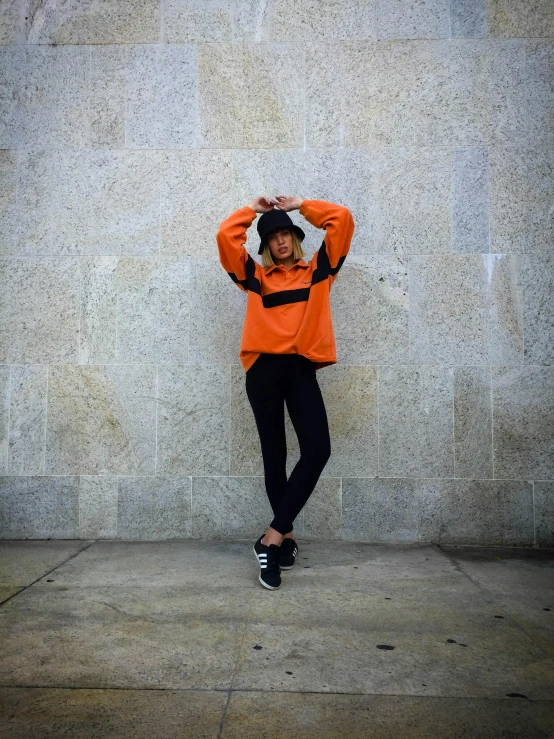 a person standing near a wall that has cement on it