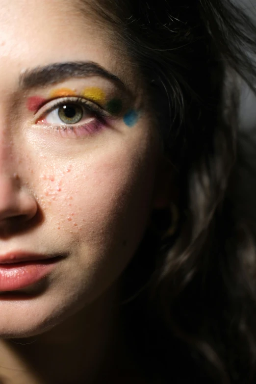 closeup of a woman's face with colorful makeup