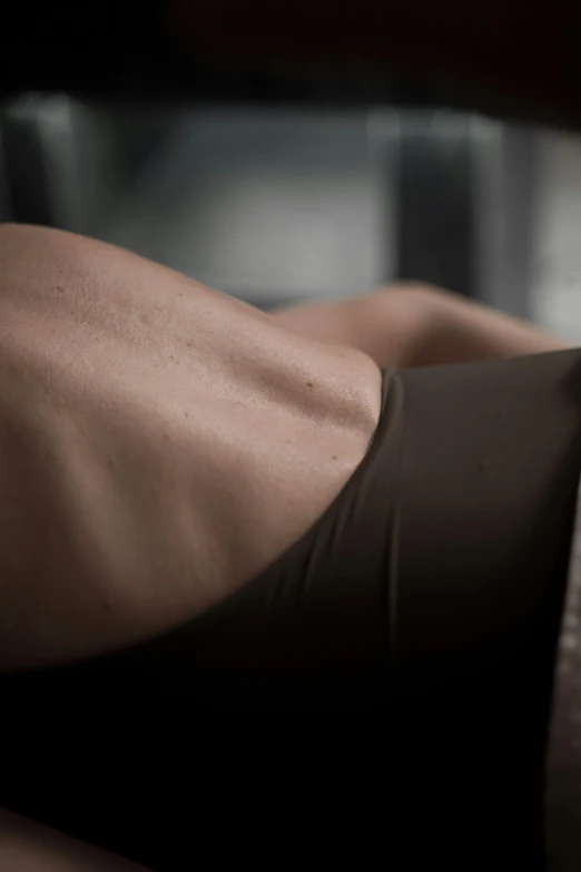 a woman lying down on top of a couch in a room