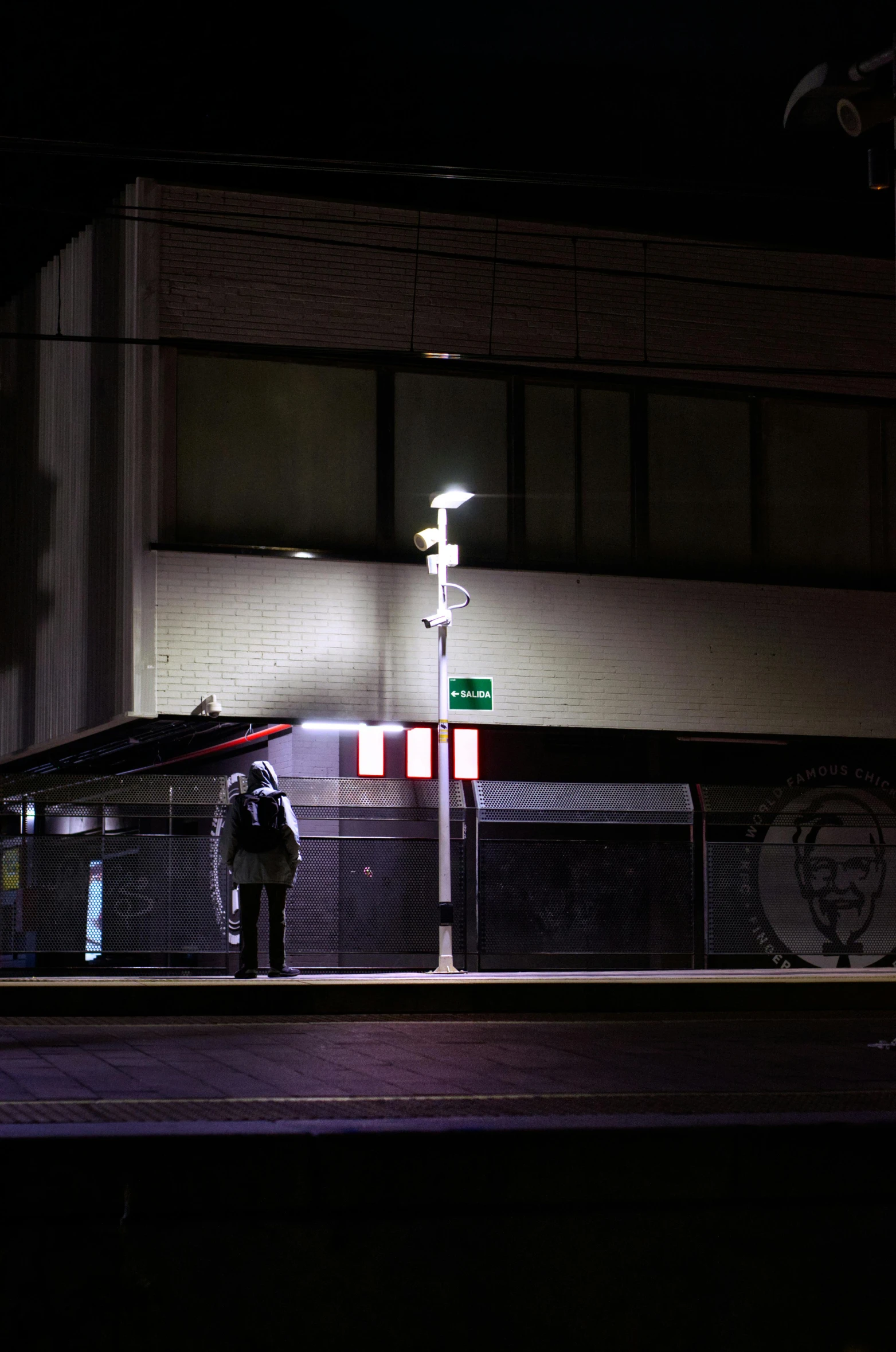 a person standing in the dark near a road at night