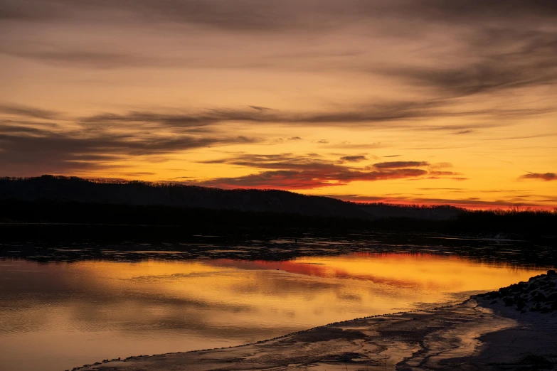 an orange and pink sunset in the distance