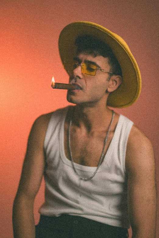 a man smoking in a straw hat and glasses