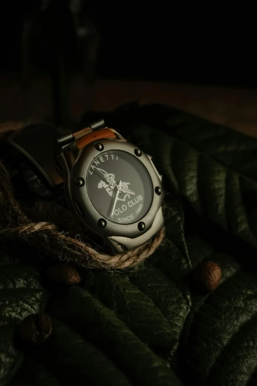 a watch is laying on a piece of fabric