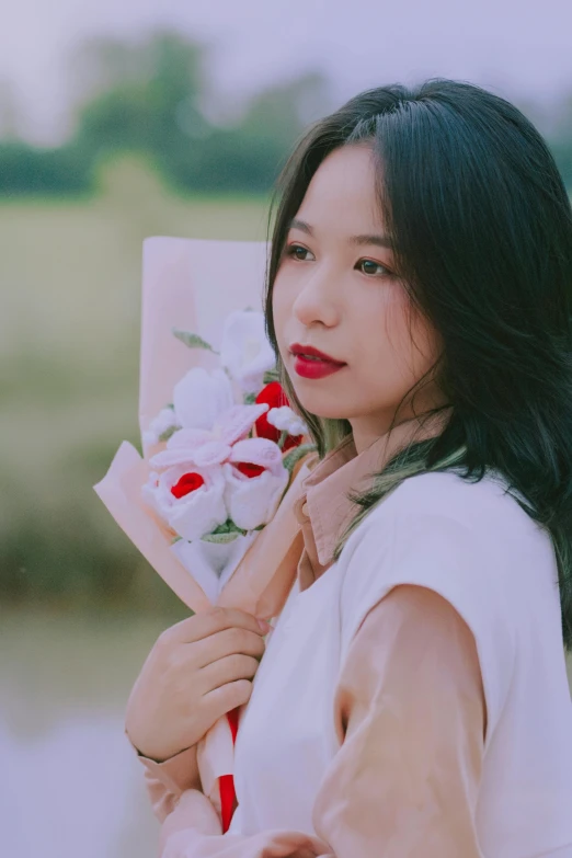 a woman standing with flowers on her arm