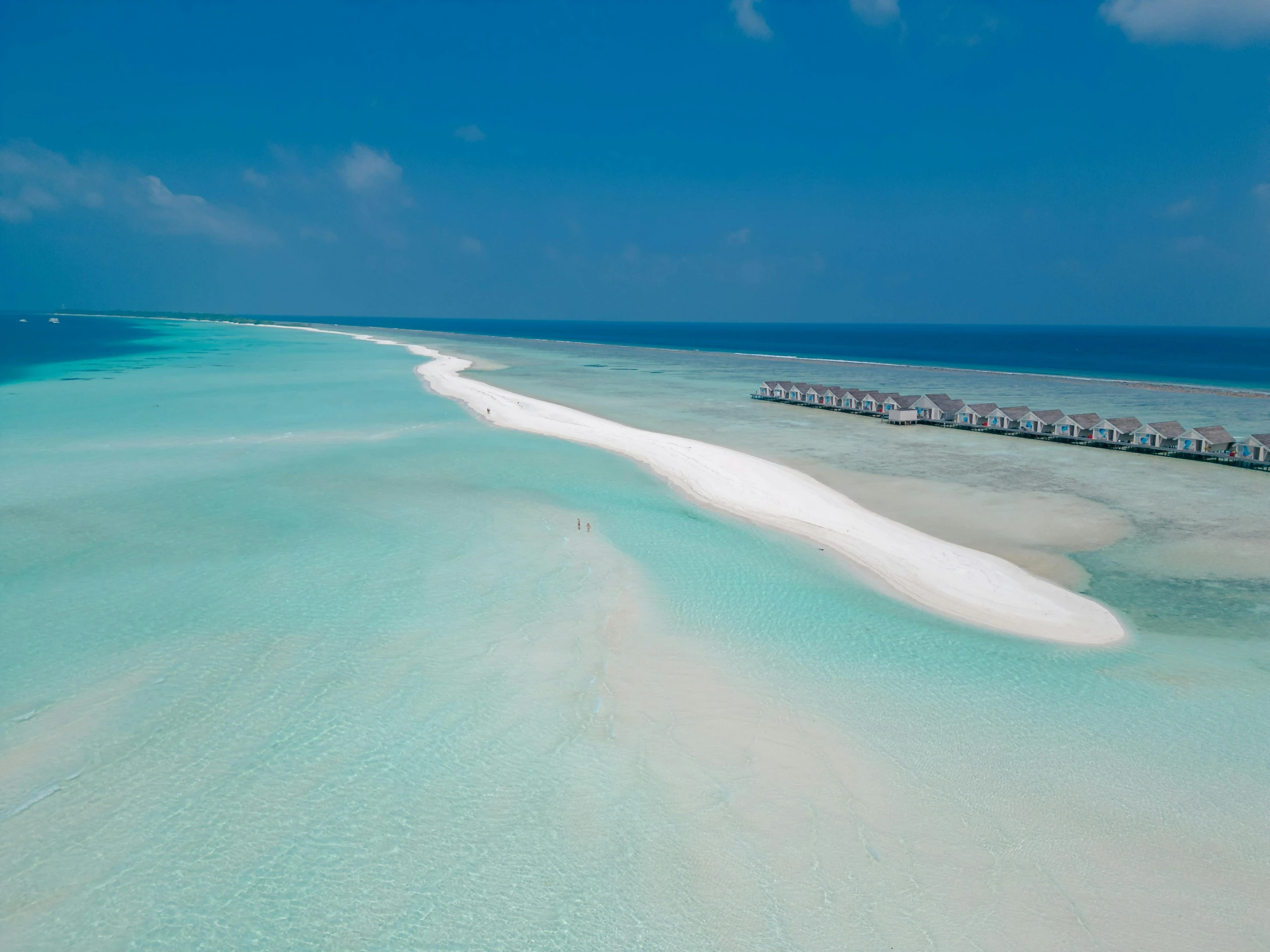 a long body of water with a beach in the distance