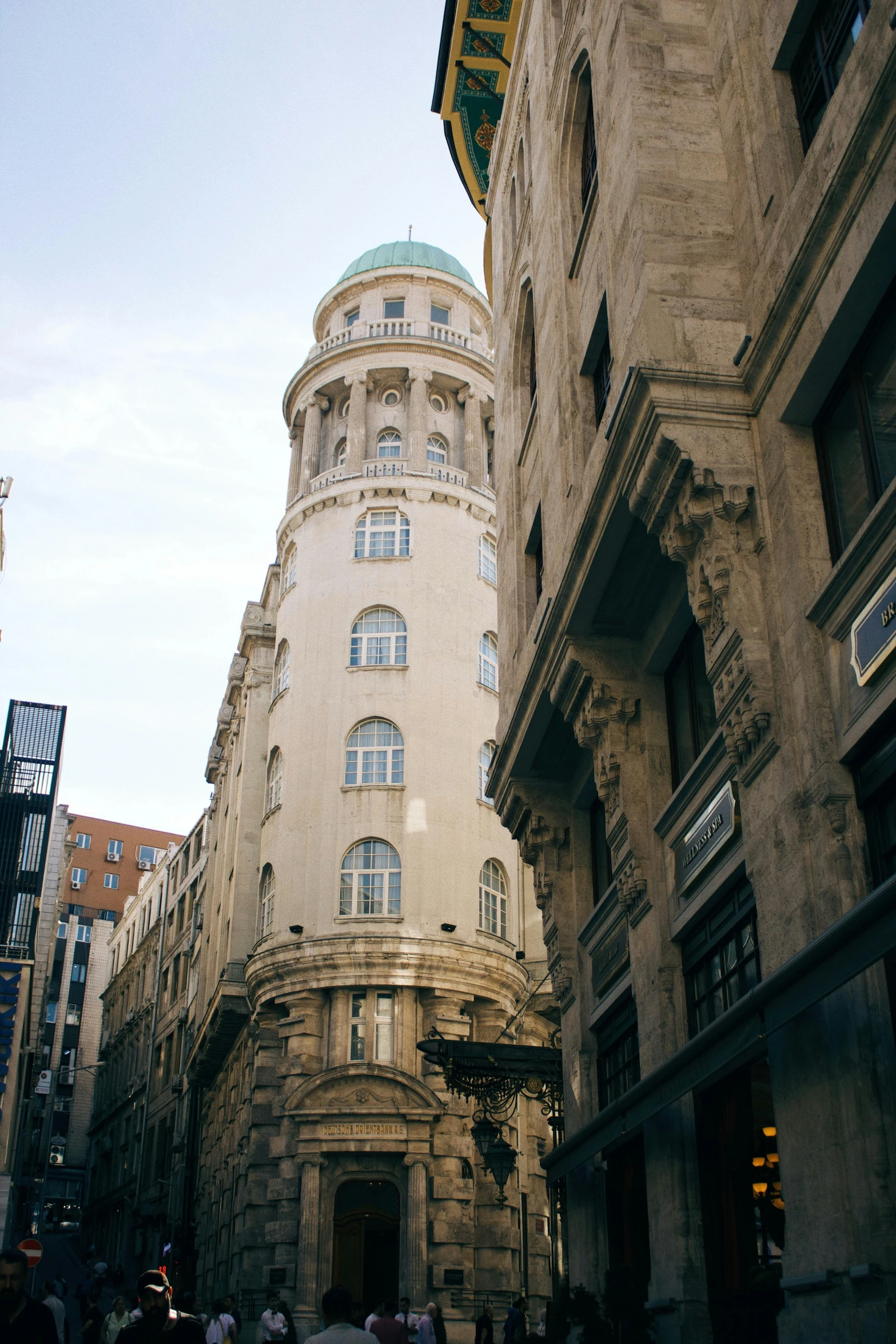 a clock mounted to the side of a tall building