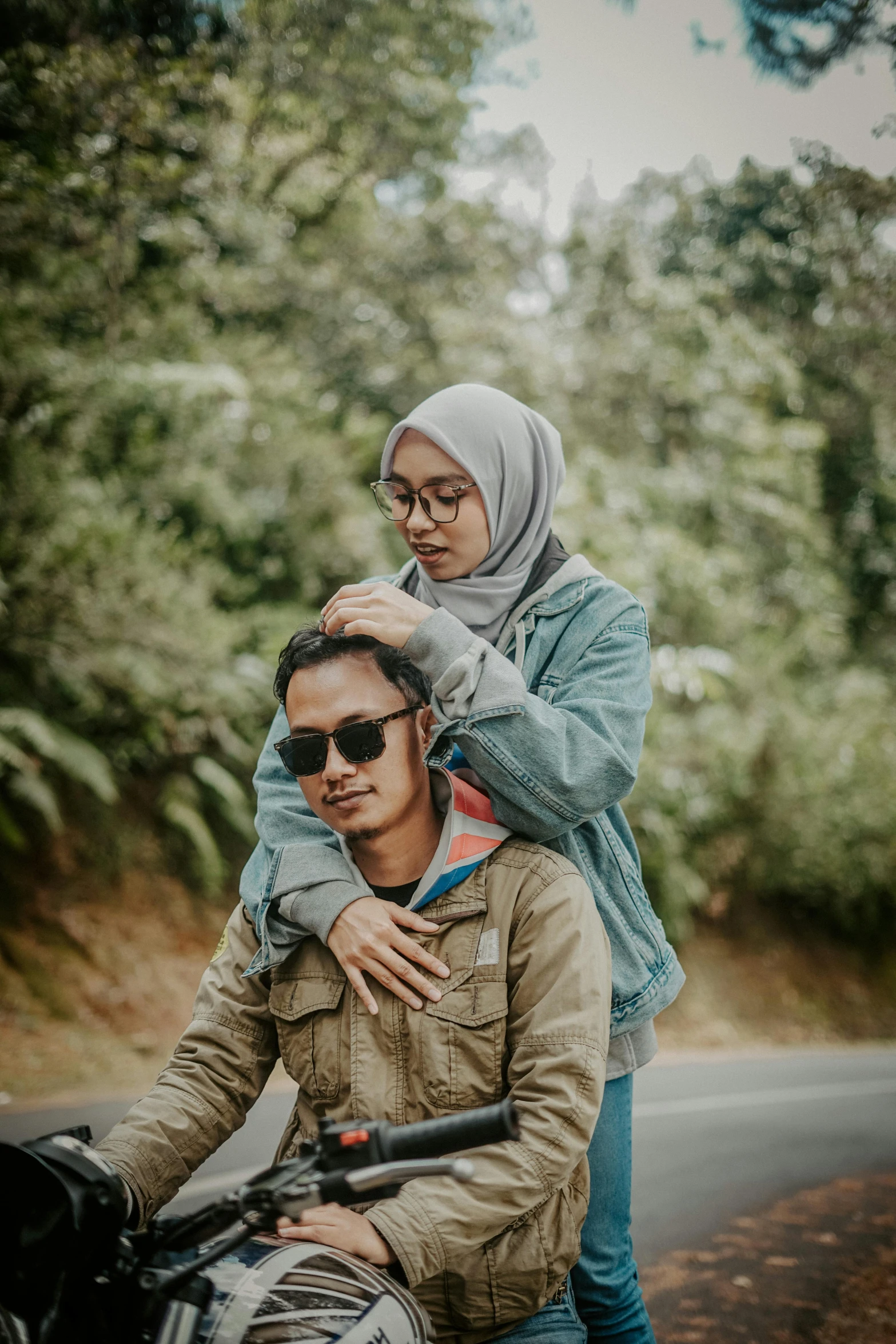 man carries on back of woman on the street