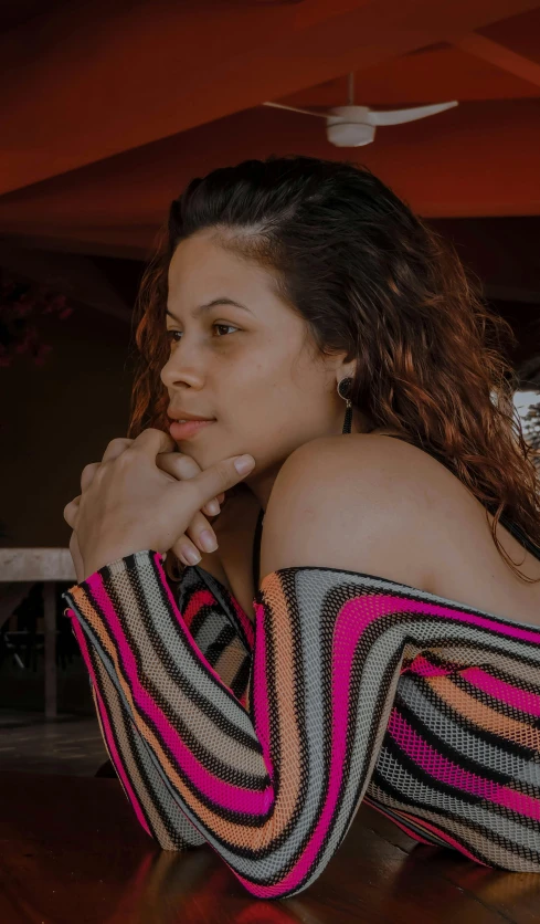 a woman is sitting on the floor with her hands in her chin