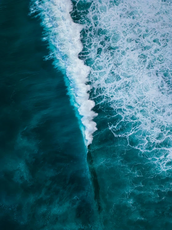 a large body of water next to a sandy shore