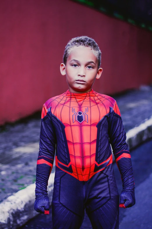 an adorable little boy dressed in his spiderman costume