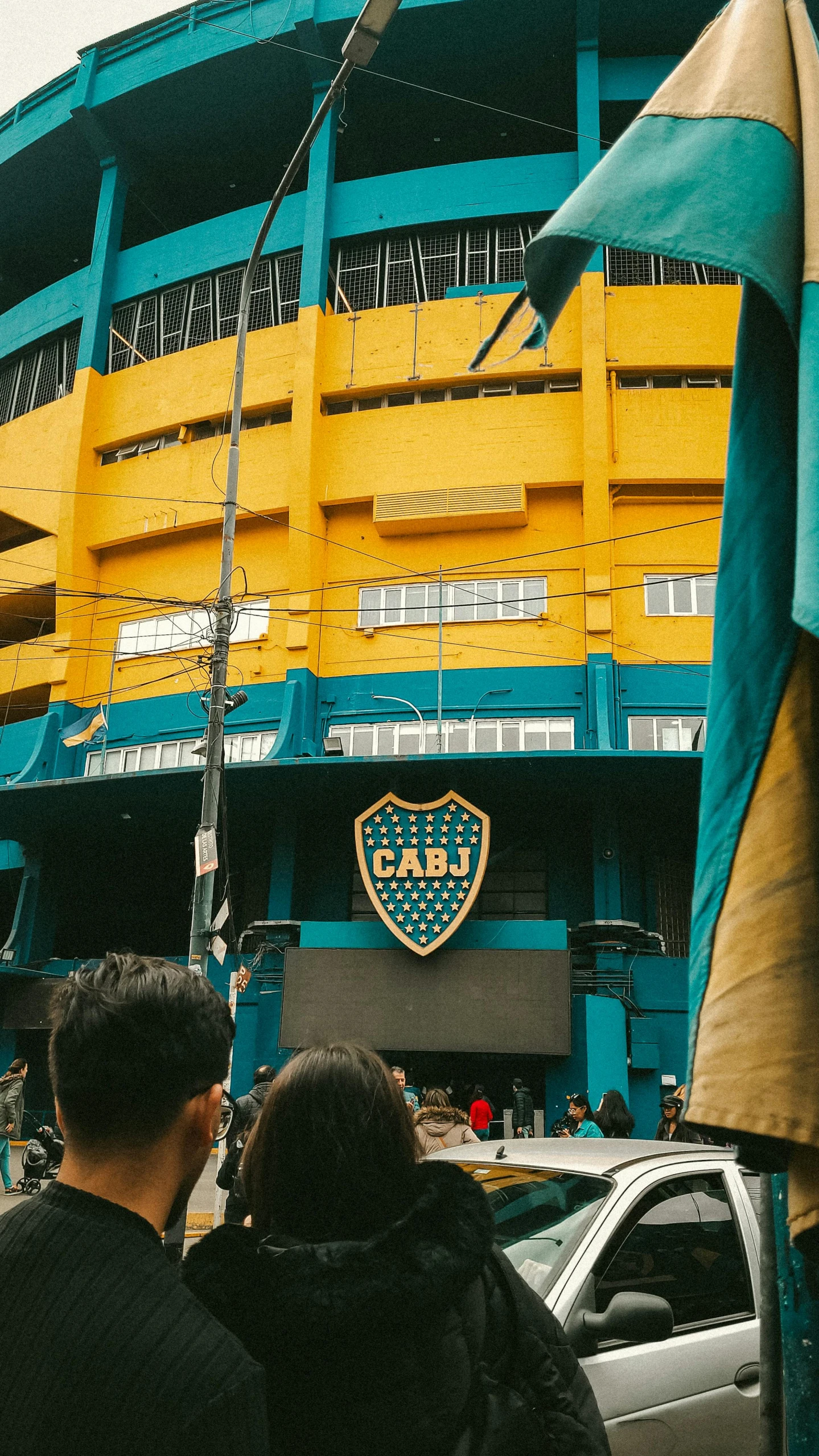 two men standing in front of a football stadium