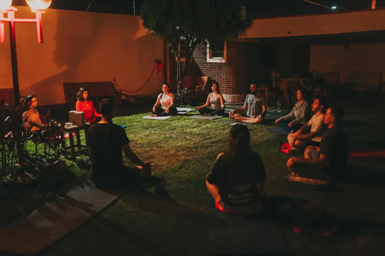 people sit and sit in the grass and eat