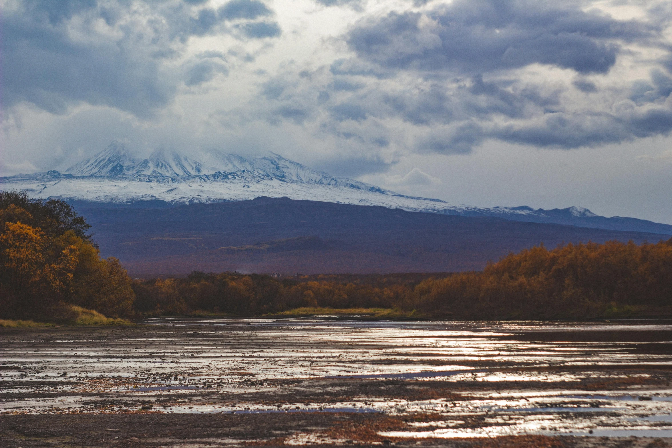 the snow capped mountains are in the distance