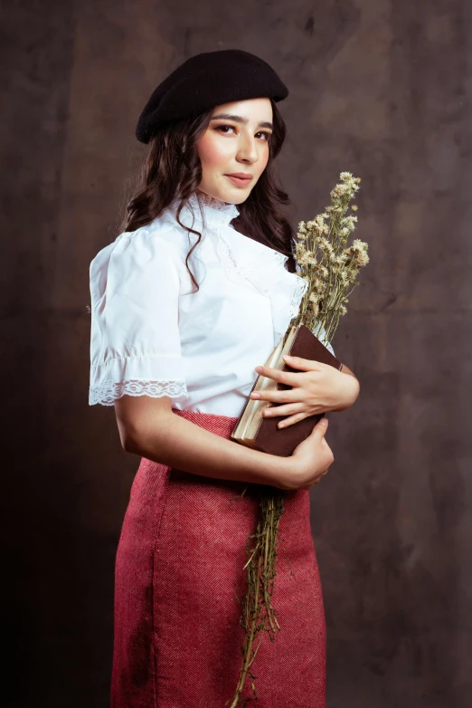 a woman standing with a bunch of flowers