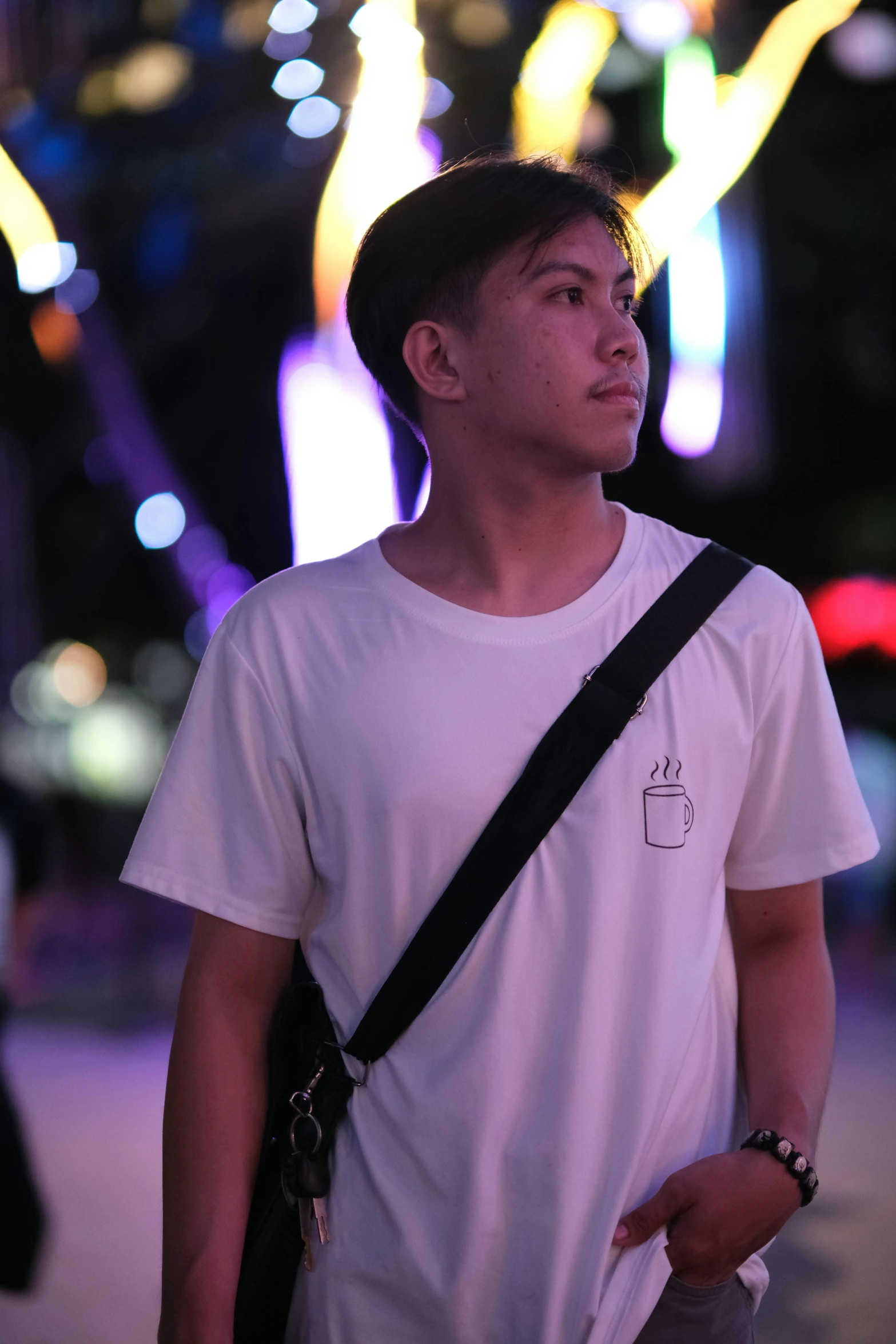 a man in white shirt standing on street corner