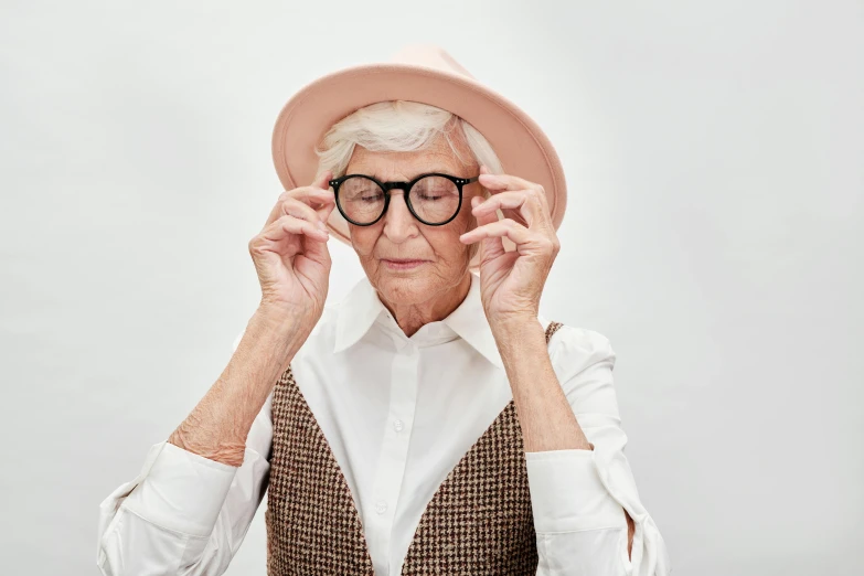 an old woman wearing a pink hat and glasses