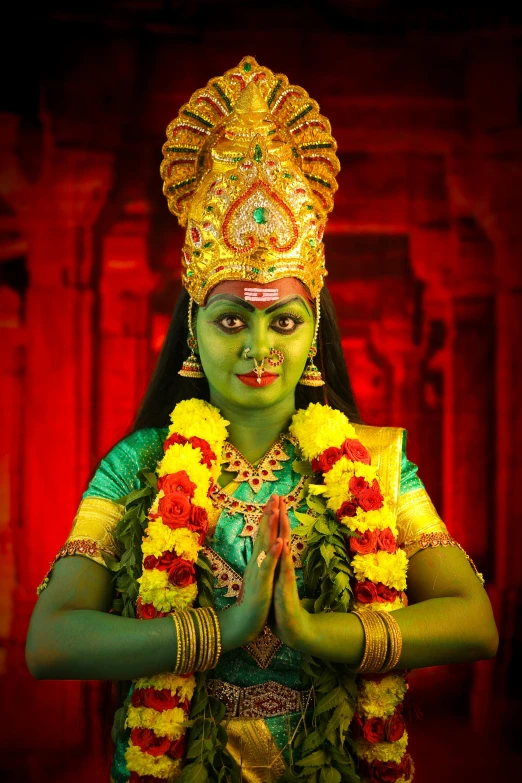 woman in a costume standing by a red background