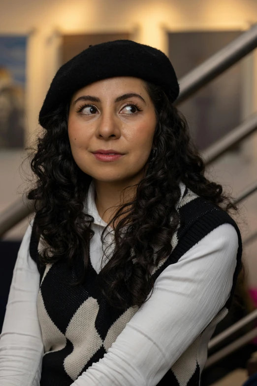 a  in a hat and a sweater looking up