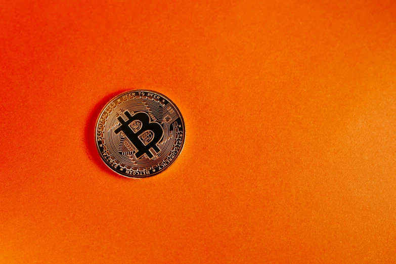 an orange background with a close up of a coin