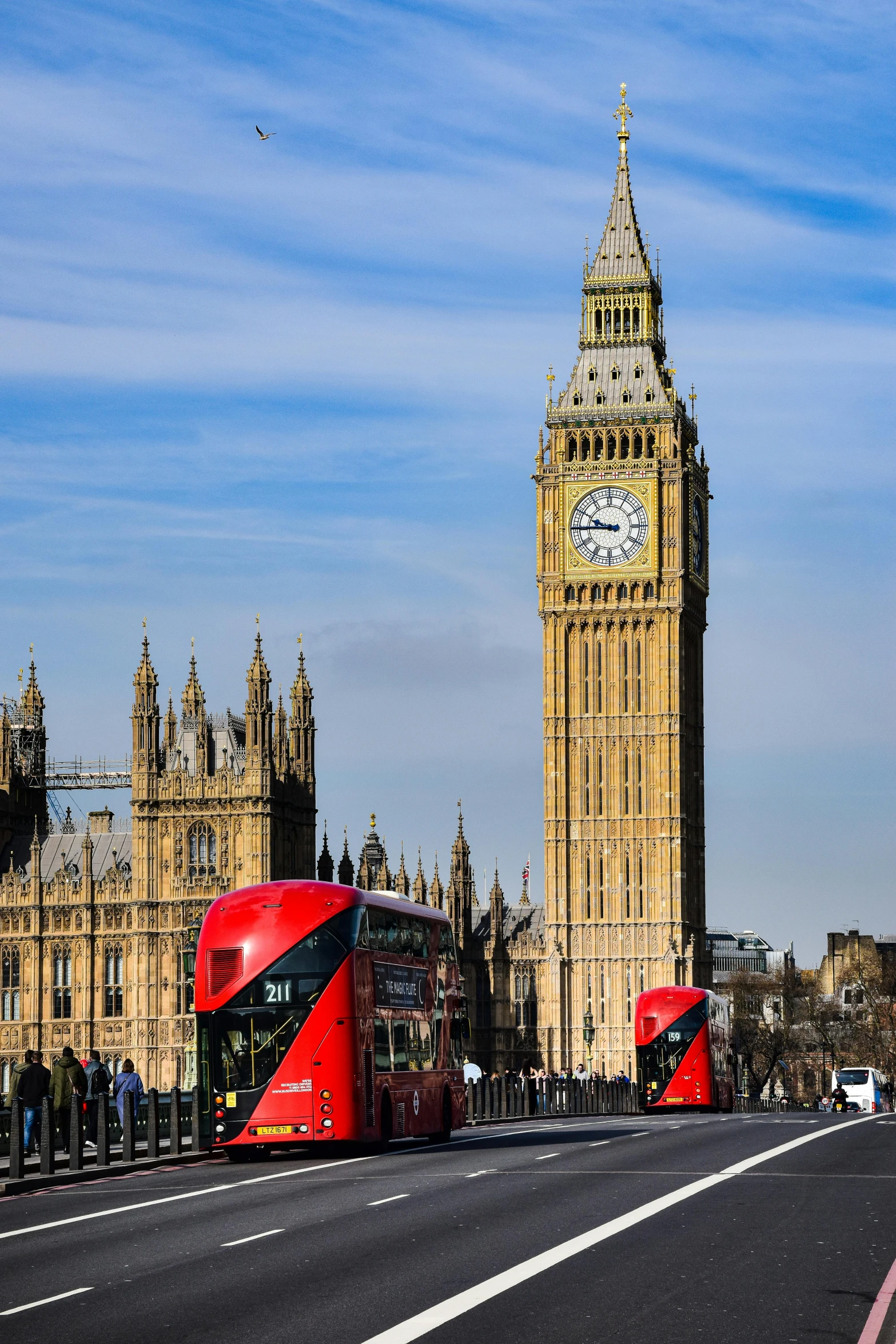 double decker bus on the street with large building in background