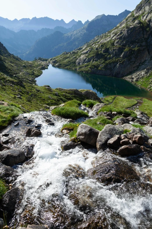 a body of water surrounded by rocky mountains