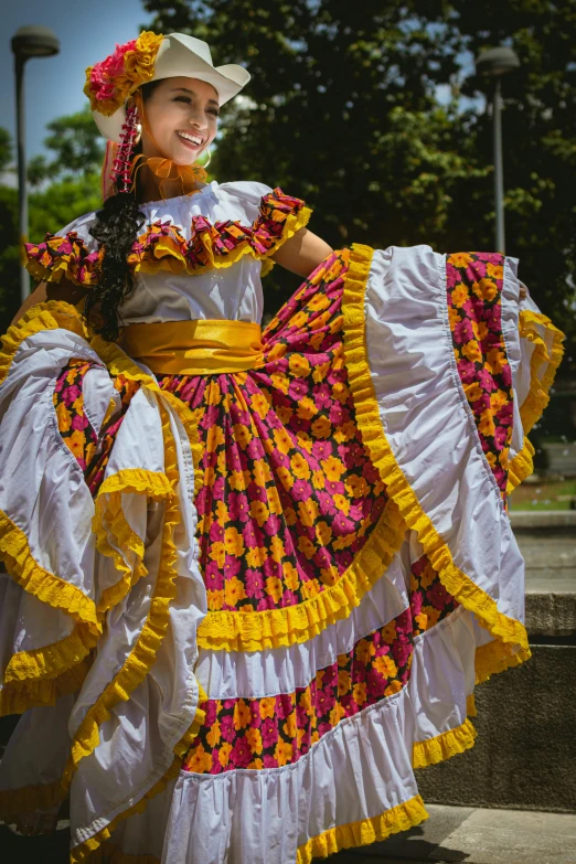 a woman wearing mexican clothing, smiles at the camera