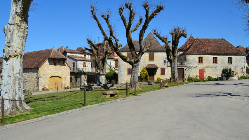 a small village with stone houses and trees